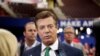 FILE- Paul Manafort talks to reporters on the floor of the Republican National Convention, July 17, 2016, in Cleveland.