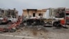 FILE - Damaged vehicles and buildings are seen at Mitiga airport after it was hit by shelling, in Tripoli, Libya, May 10, 2020. 