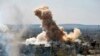FILE - In this photo released by the Syrian official news agency SANA, smoke rises after Syrian government airstrikes and shelling hit in Hajar al-Aswad neighborhood held by Islamic State militants, southern Damascus, April 22, 2018.