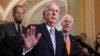 FILE - Senate Majority Leader Mitch McConnell, R-Kentucky, flanked by Sen. John Thune, R-South Dakota, left, and Majority Whip John Cornyn, R-Texas, speaks with reporters about Supreme Court nominee Brett Kavanaugh at the Capitol in Washington, Sept. 18, 2018.