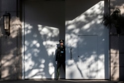 A Chinese paramilitary soldier secures an entrance at the Jingxi Hotel in Beijing, Oct. 28, 2019.